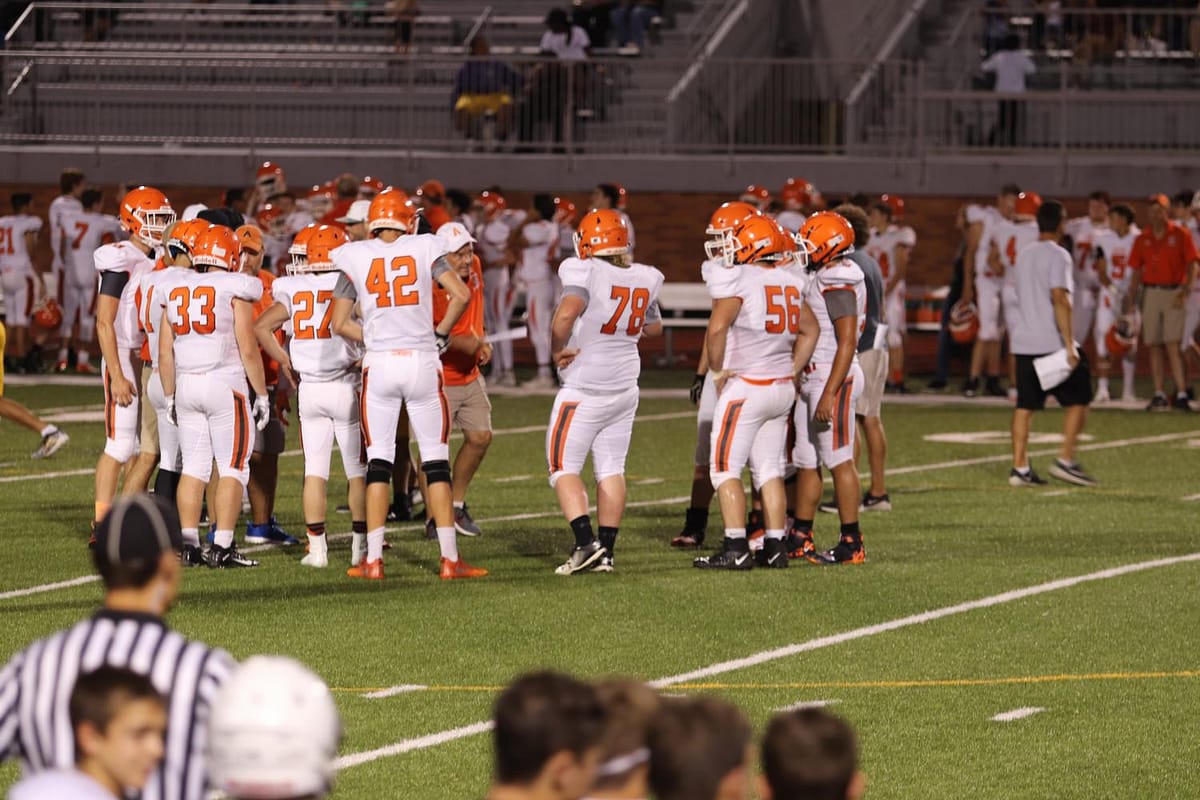 The boys gather together to decide their next play.