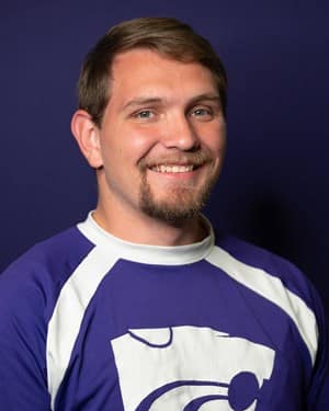 Zach Cooper, AHS agriculture teacher and FFA Adviser, is also a cheerleader for Kansas State University. Photo credit: kstatesports.com
